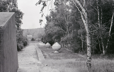 A view of the path through the memorial site, along which concrete blocks shaped like urns have been placed.