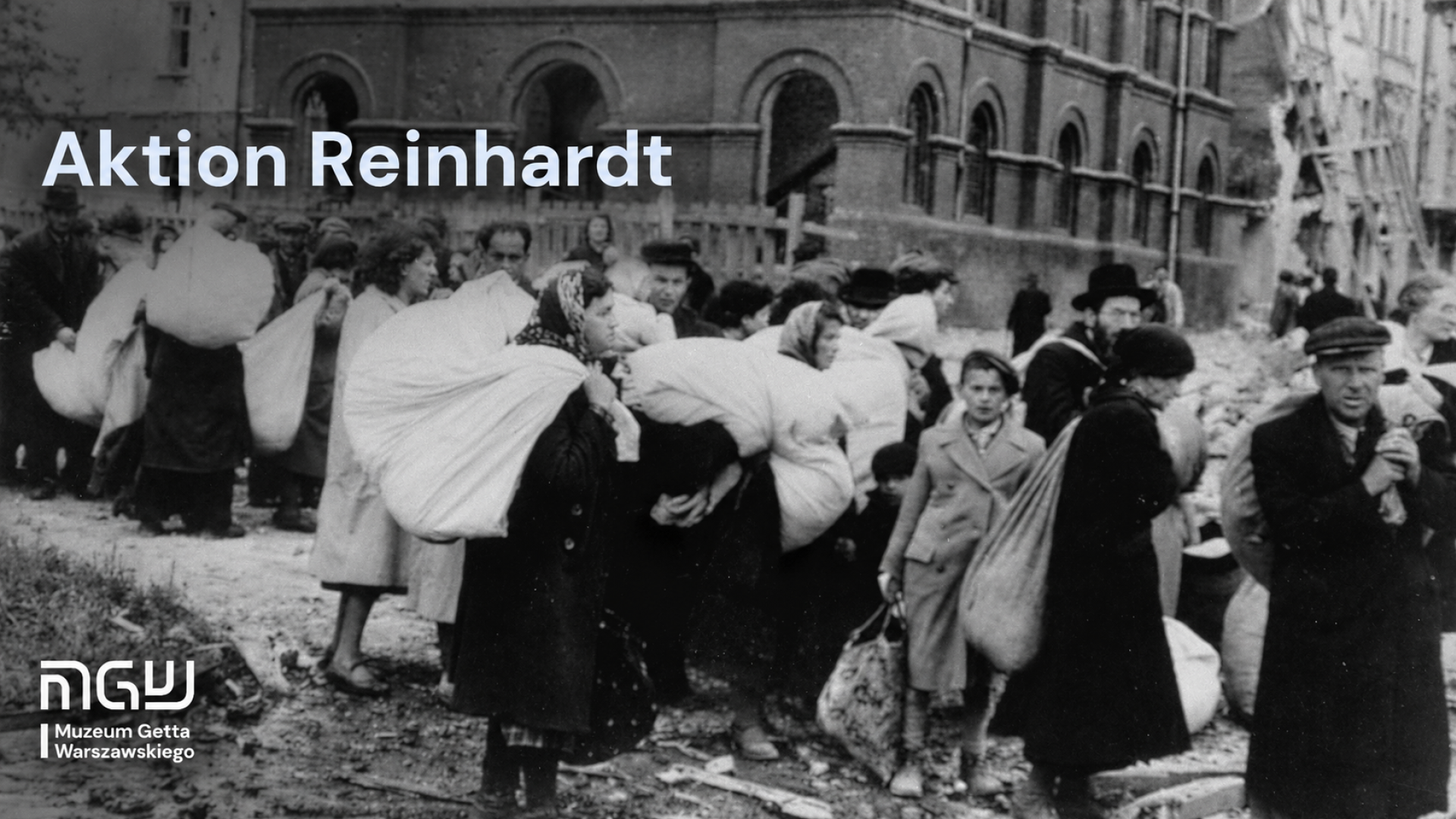 A black-and-white photograph showing a group of people carrying large bundles among damaged buildings. The words “Aktion Reinhardt” appear in the upper left corner, with the Warsaw Ghetto Museum logo below.
